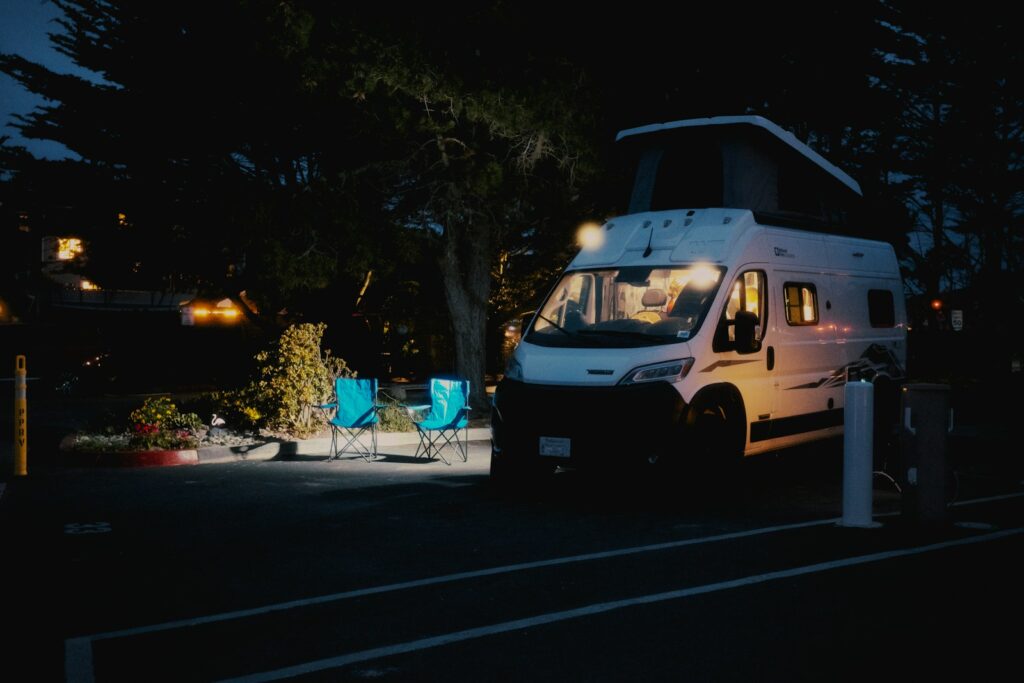 Campervan parked at a campsite at night.